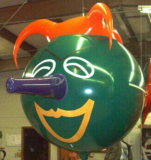 custom funny joker shape helium advertising balloon green, orange, blue and yellow in color
